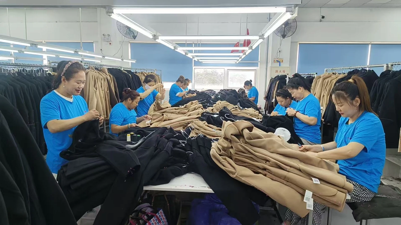 Nanong team inspecting and finishing coats in the factory